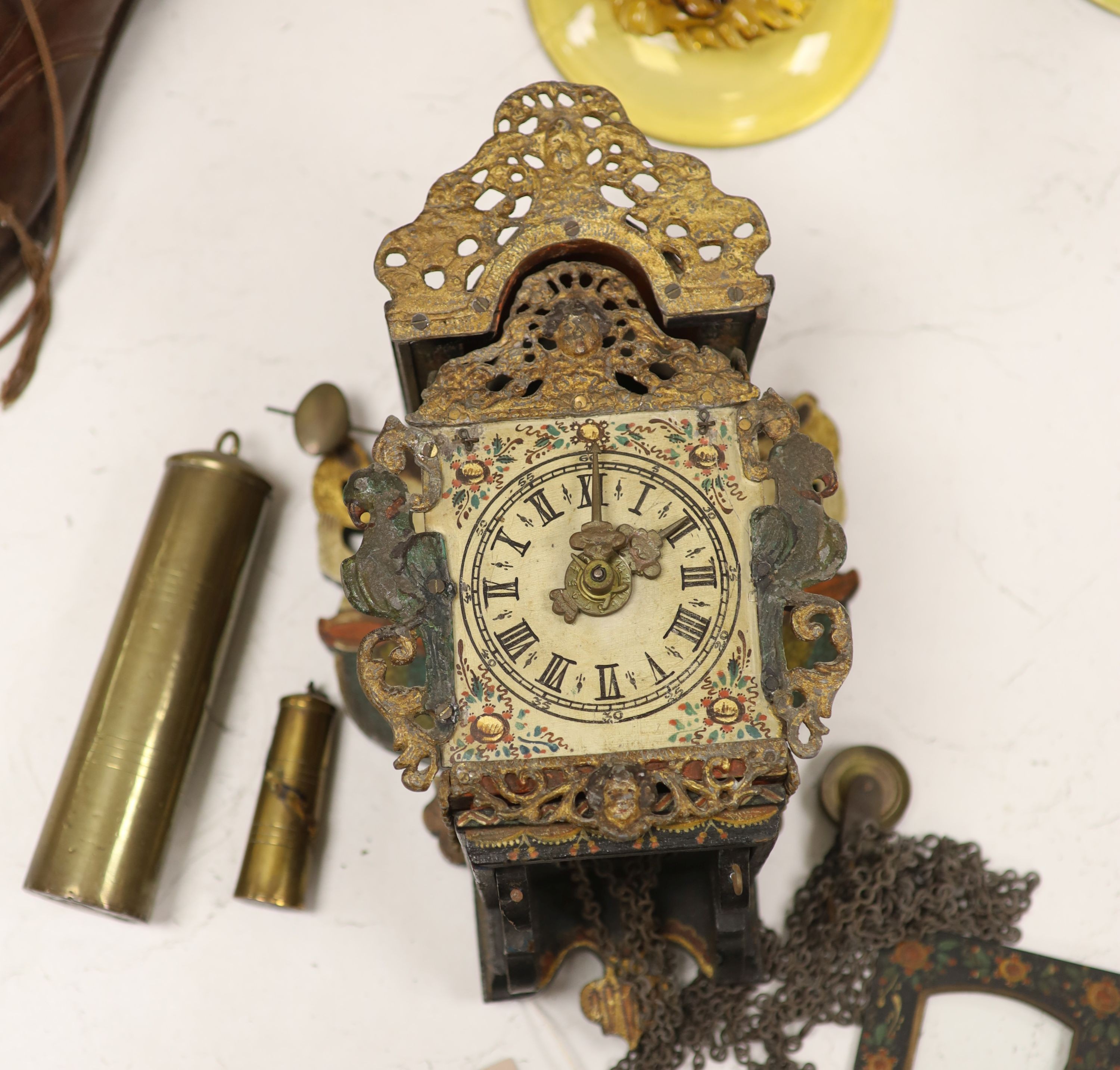 A German painted wood and metal wall clock retailed by Camerer, Cuss & co